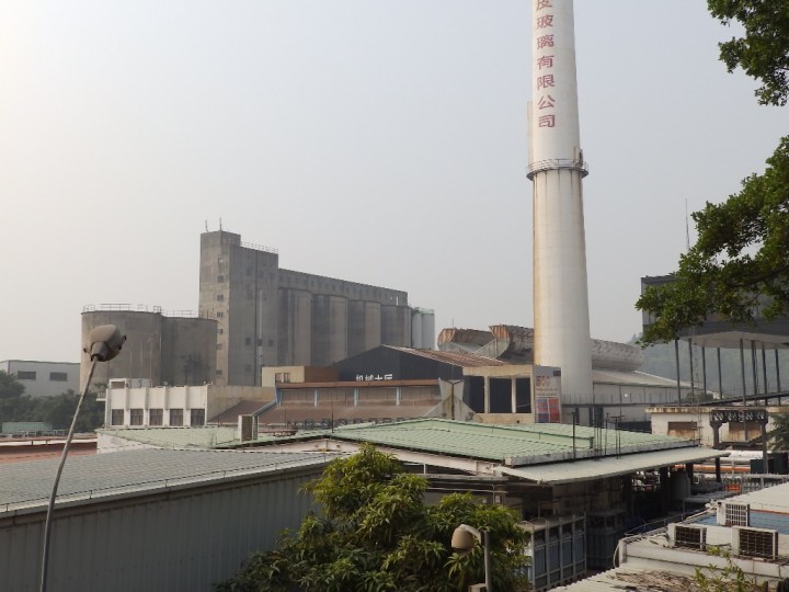 The former glass factory (chimney and buildings behind) amidst still active industries and factories. The transformation of the glass factory complex into the Value Factory was a first step to preserve this as industrial heritage and use that as catalyst for future development.